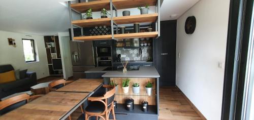 a kitchen with a long table and a table and chairs at appartement standing Gérardmer jacuzzi in Gérardmer