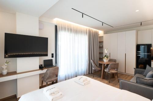 a hotel room with a living and dining room at Volos Inn Hotel in Volos