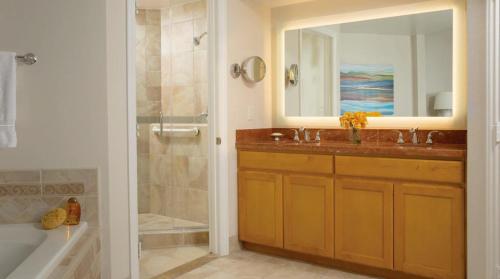 a bathroom with a sink and a shower and a mirror at The Exclusive Marriott's Newport Coast Villas in Newport Beach