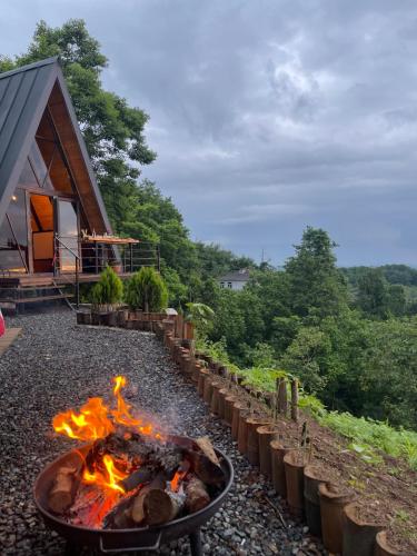 a fire pit in front of a cabin at A-Frame Rest-Art in Batumi