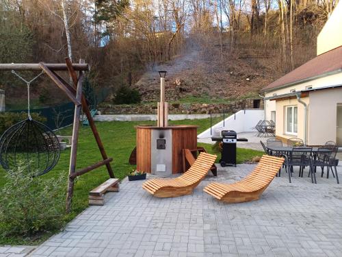 a patio with chairs and a grill and a table at U kapličky, Boskovice in Boskovice