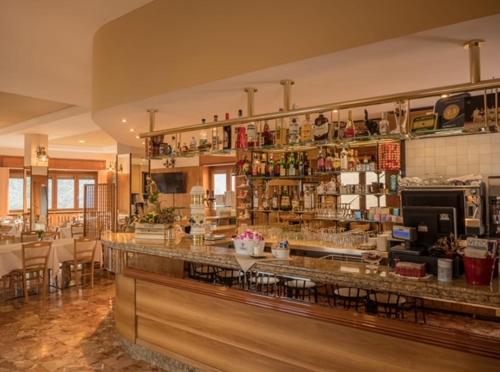a restaurant with a counter and a bar in a room at Albergo De Jean in Garzeno