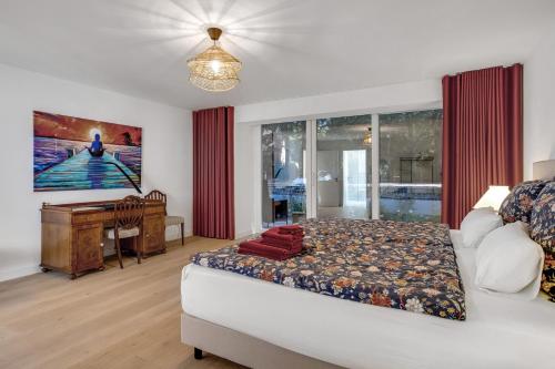 a bedroom with a bed and a desk in it at Villa Relaxotic Apartments in Glücksburg