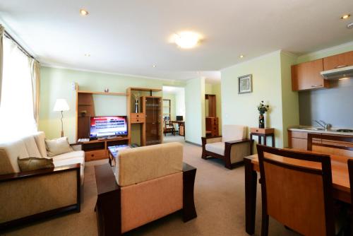 a living room with a couch and a dining room at Narantuul Hotel in Ulaanbaatar