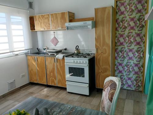 a kitchen with a stove top oven in a room at Esmeralda in Mar del Plata