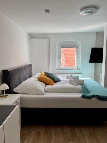 a large bed in a bedroom with a window at Flores City Center Studio - Easy Self-Check-IN in Graz