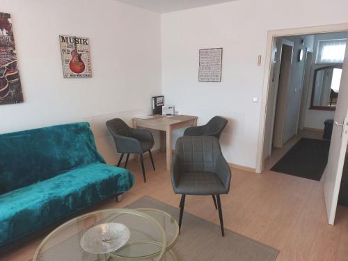 a living room with a couch and chairs and a table at Apartment-Ferienwohnung in Mainaschaff in Mainaschaff