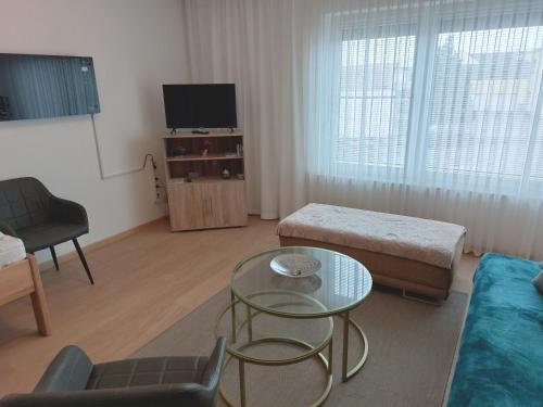 a living room with a couch and a table at Apartment-Ferienwohnung in Mainaschaff in Mainaschaff