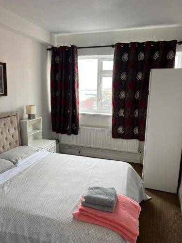 a bedroom with a bed with two towels on it at Barley Mow Hotel in Pontefract