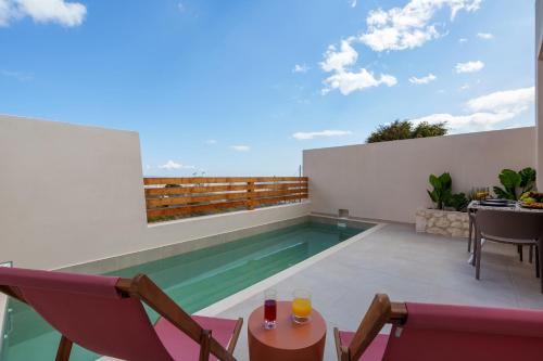 a swimming pool on the roof of a house at Sugarwhite Suites with Private not Heated Pool in Emporio Santorini