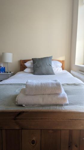 a bedroom with a bed with towels on it at Cosy Fermanagh Home - The Cosy Beech in Lisnaskea