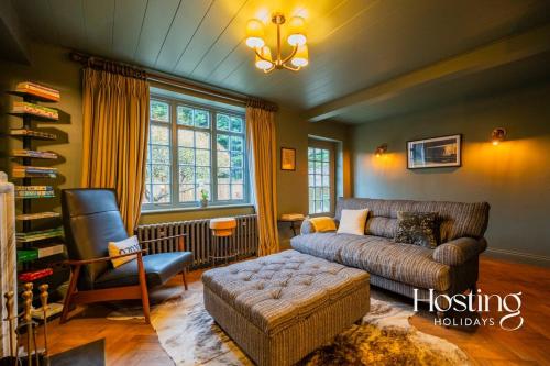 a living room with a couch and a chair at The Writers Retreat in Medmenham