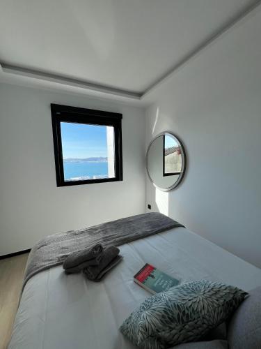 a bedroom with a bed with a mirror and a book at La Terraza del Àtico con parking incluido in Vigo