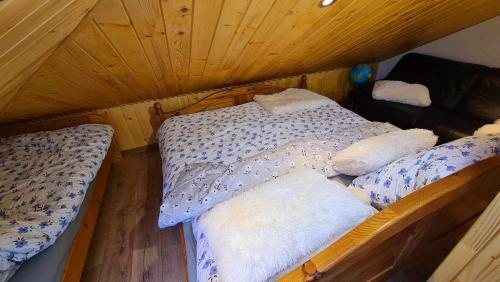 an attic bedroom with two beds in a room at Zakątek u Poety Dąbrówka in Jasło