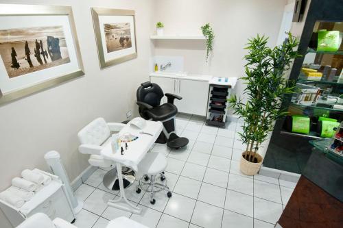 a hair salon with white chairs and a white table at Seamill Hydro Hotel in Seamill