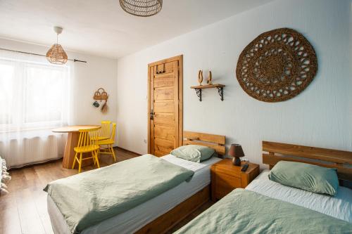 a bedroom with two beds and a table and a table at Folwark Wierzchy in Wierzchy