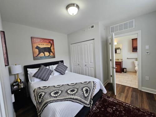 a bedroom with a bed with white sheets and pillows at One Bedroom Partment at the Inman - 202 in Champaign
