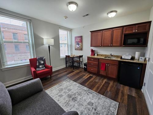 a living room with a couch and a kitchen at One Bedroom Partment at the Inman - 202 in Champaign