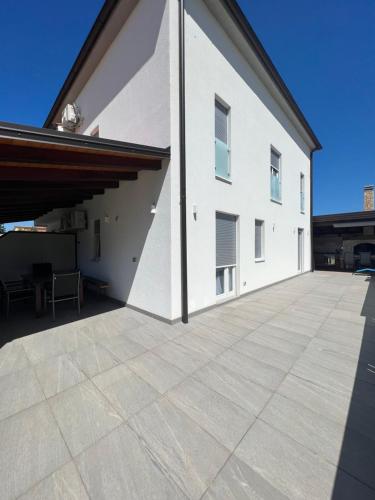 a large white building with a large patio at Apartment maslina in Poreč