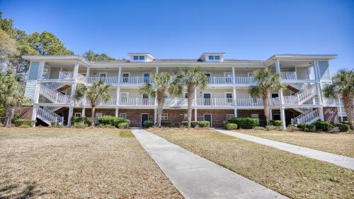 a large building with palm trees in front of it at 612 Willow Bend Condo in North Myrtle Beach