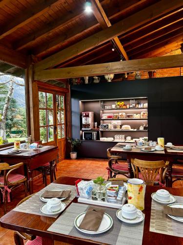 a dining room with tables and chairs in a building at Apartamentos Rurales L'Arquera in Llanes