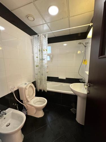 a bathroom with a toilet and a sink at Master Bed Room Shared Apartment Flat 1301 in Abu Dhabi