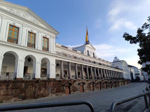 a large white building on a street at Hotel Colonial - Casa Francisco in Quito