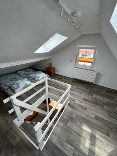 um quarto no sótão com uma cama e uma janela em Ferienwohnung Niesky em Niesky