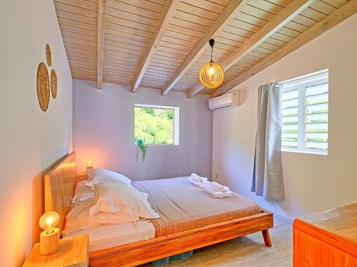 a bedroom with a bed and a window at Appartement Saint-Martin , 2 pièces, 3 personnes - FR-1-734-15 in Saint Martin