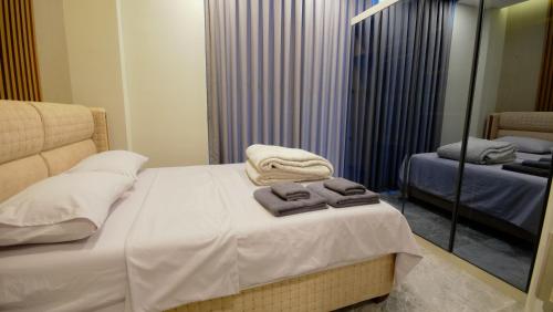 a bedroom with a bed with towels on it at Bodrum Ada Apart Otel Turgutreis in Mugla