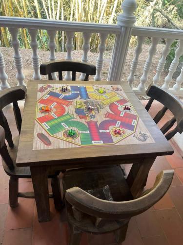 a wooden table on a porch with two chairs at Hotel campestre los Arrieros in Guaduas