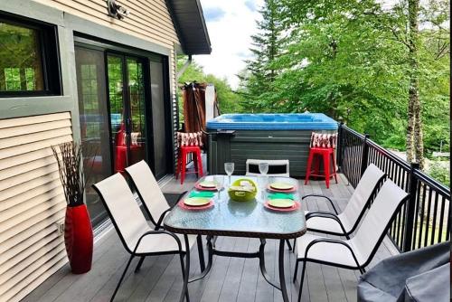 a patio with a table and chairs and a grill at 23 Chemin des Skieurs in Stoneham
