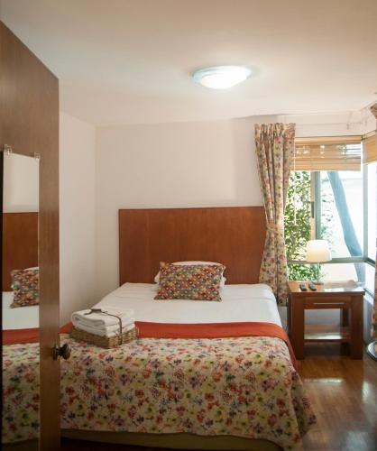 a bedroom with a bed and a window at Chalet del Carmen, Coyoacán in Mexico City