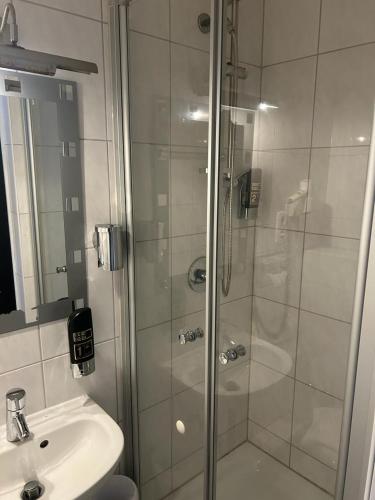 a bathroom with a shower and a sink at WestEnd#102 in Frankfurt