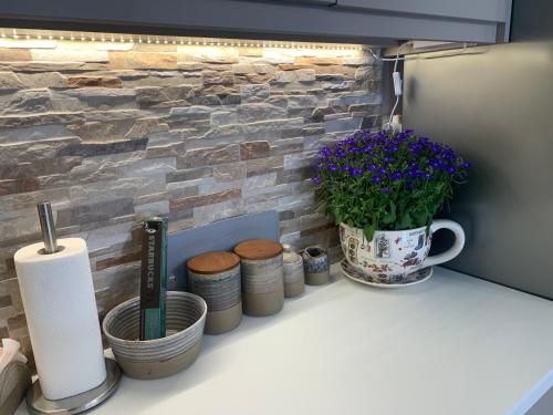 a counter with a toilet paper and flowers on it at Pelion 7 Lives in Tsagarada