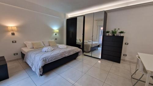 a bedroom with a bed and a large mirror at LG colosseum Rome apartment in Rome