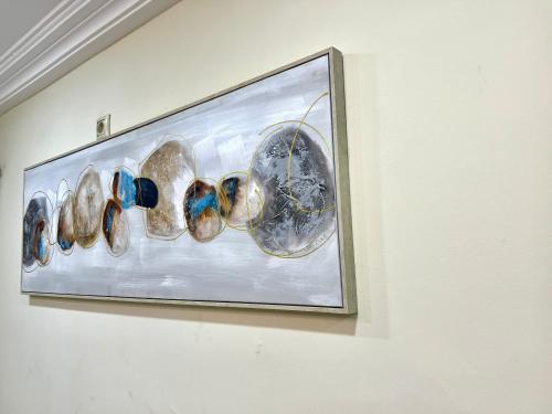 a framed picture of plates on a wall at Hacienda Residence in Yaoundé