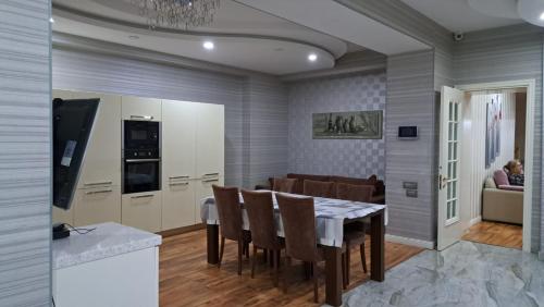 a kitchen and dining room with a table and chairs at Vip Apartment Azure Tower in Baku