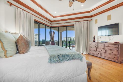 a large bedroom with a large bed and a television at Villa Tuscana in Destin