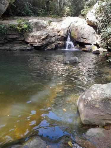 a waterfall in the middle of a pool of water at Hotel campestre los Arrieros in Guaduas