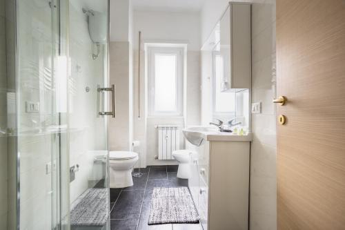 a bathroom with a toilet and a sink and a shower at Portside Aparthotel in Rome