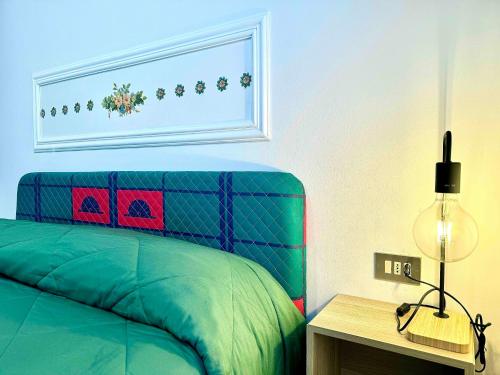 a bedroom with a bed and a table with a lamp at Villetta Relax Cansano Spa in Cansano