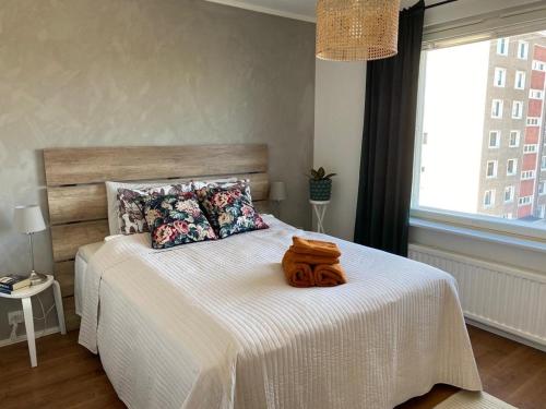 a bedroom with a large bed with a wooden headboard at Private apartment near Ruissalo, Castle, Harbour - AC, Free parking in Turku