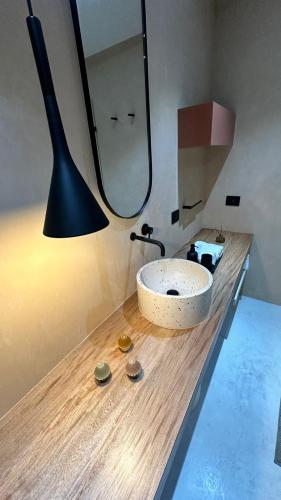 a bathroom with a sink and a large mirror at Hotel Boutique Miranda in Oaxaca City