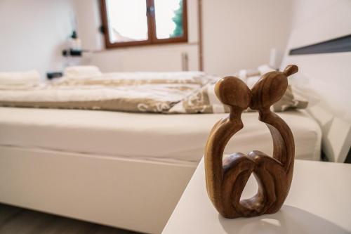 a sculpture of two people standing next to a bed at Apartma Ksela in Mala Nedelja