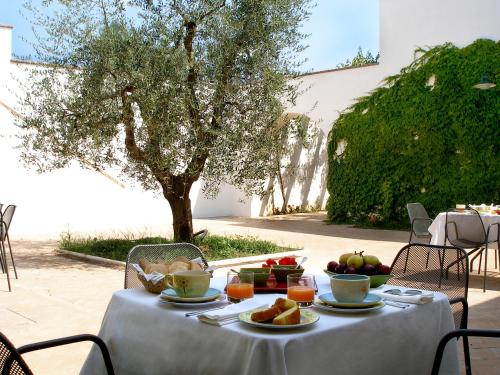 a table with a plate of food on it at Relais Masseria Cardillo in Metaponto