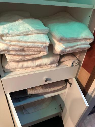 a drawer filled with towels in a closet at Romantic apartman in Szeged