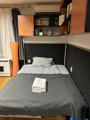 a bed with a towel on it in a room at Romantic apartman in Szeged