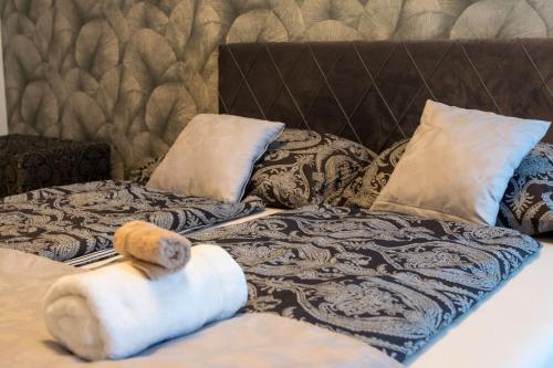 a bed with a stuffed animal on it with pillows at Luxusní Apartmán NMNM Essence in Nové Město na Moravě