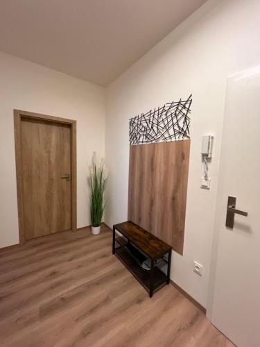 a room with a door and a bench in it at Luxusní Apartmán NMNM Essence in Nové Město na Moravě